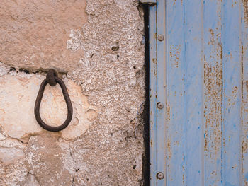 Close-up of rusty metal on wall in a village