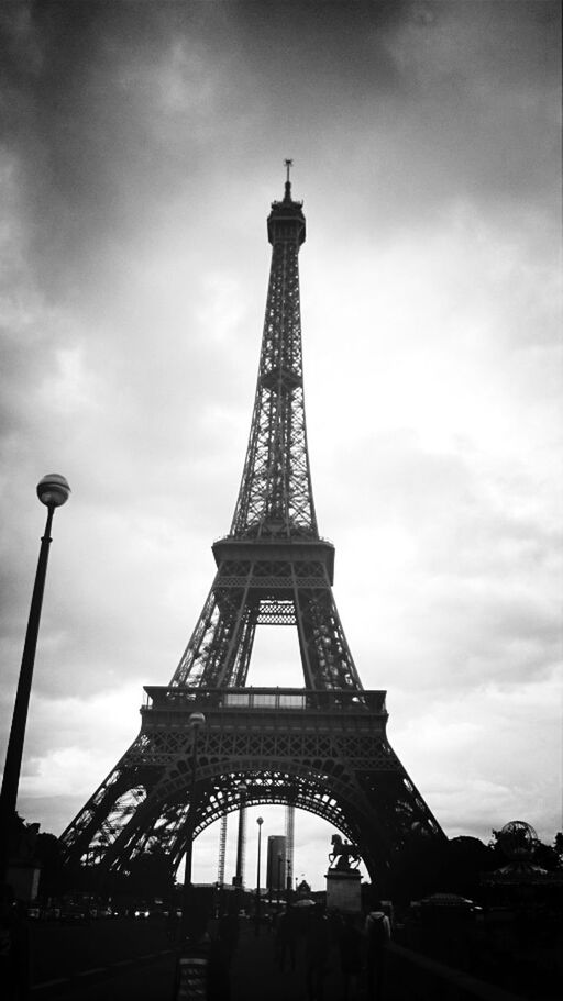 eiffel tower, architecture, international landmark, built structure, famous place, tower, sky, tall - high, travel destinations, low angle view, tourism, capital cities, culture, travel, metal, history, cloud - sky, cloudy, city, tall