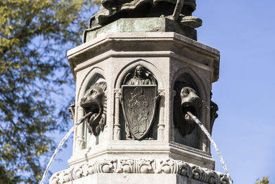 Low angle view of statue against building