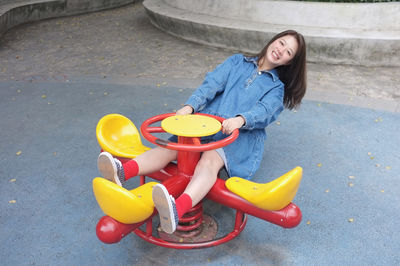 High angle view of girl playing with push scooter on street