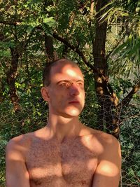 Portrait of shirtless young man looking away