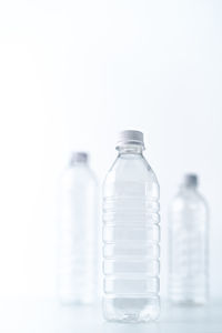 Close-up of glass bottle against white background