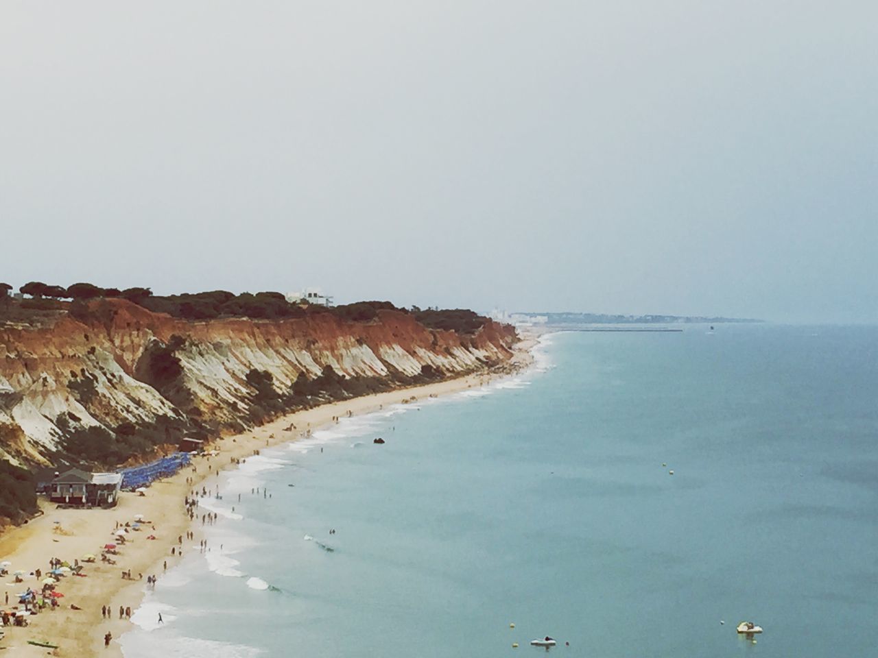 water, sea, clear sky, copy space, horizon over water, tranquil scene, tranquility, beach, scenics, beauty in nature, nautical vessel, nature, transportation, boat, shore, bird, day, incidental people, travel, mode of transport