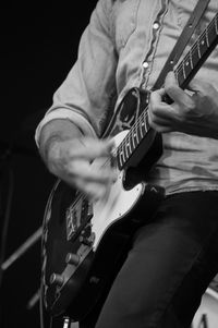 Close-up of man playing guitar