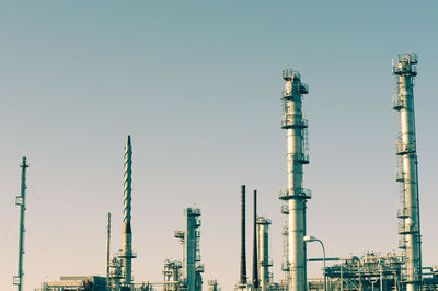 Low angle view of smoke stack against clear sky