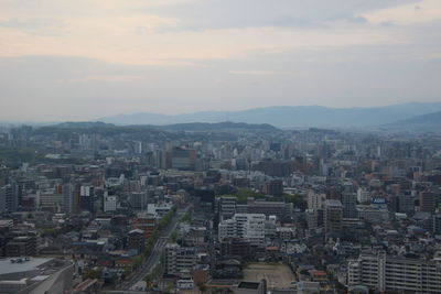 High angle view of buildings in city against sky during sunset