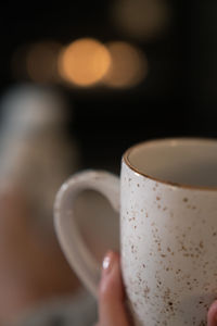 Close-up of hand holding coffee cup