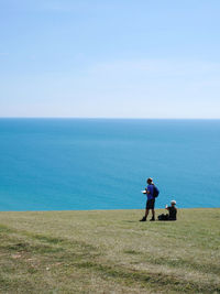 Man on sea shore against sky