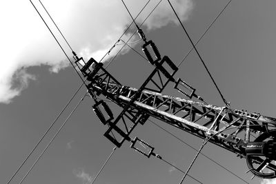 Low angle view of cranes against sky