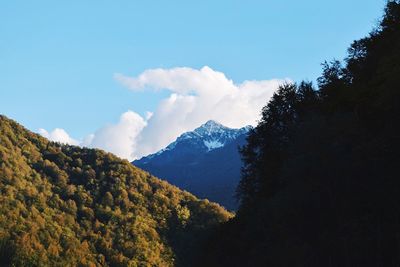 Scenic view of mountain range against cloudy sky