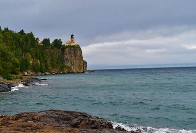 Scenic view of sea and buildings against sky