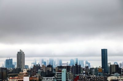 High angle view of cityscape against cloudy sky