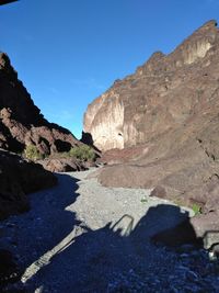 Scenic view of mountains against clear blue sky