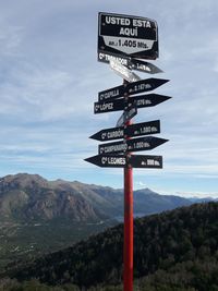 Information sign on landscape against sky