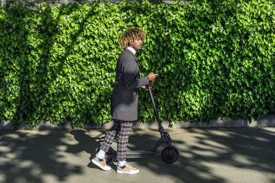 Side view of boy riding bicycle