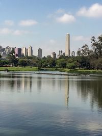 Scenic view of river with city in background