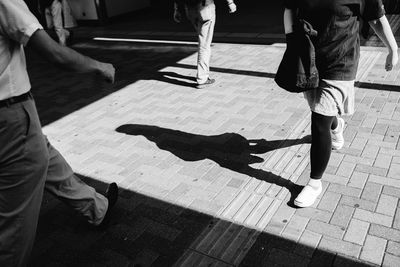 Low section of people walking on street