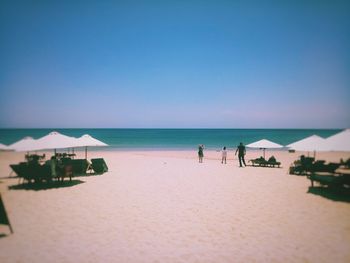 Scenic view of beach against clear blue sky