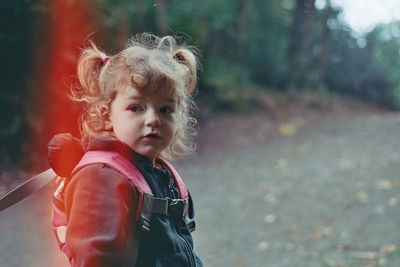 Portrait of boy standing outdoors