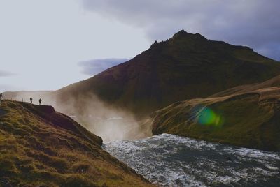 Scenic view of waterfall against sky