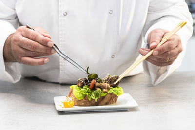 Midsection of man preparing food