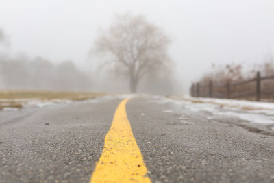 Surface level of road against sky during winter