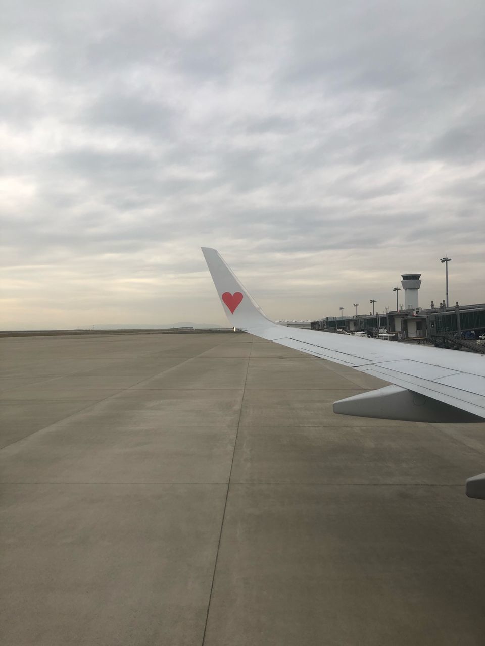 cloud - sky, sky, airplane, air vehicle, transportation, aircraft wing, airport, airport runway, mode of transportation, travel, no people, nature, runway, day, sunset, outdoors, motion, journey, flying, road, aerospace industry, concrete