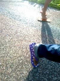 Low section of man walking on street