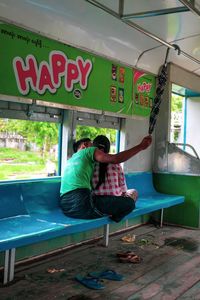 Rear view of couple sitting on chair