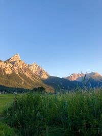 Scenic view of mountains against clear blue sky