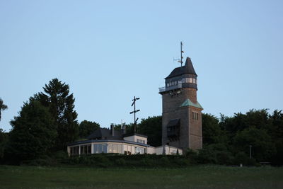 Building on field against clear sky