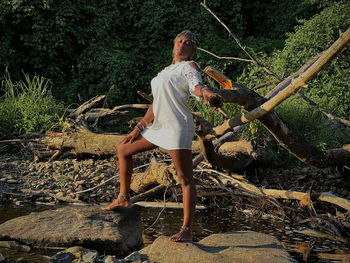 Full length of woman standing on rock