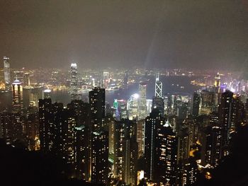 High angle view of city lit up at night