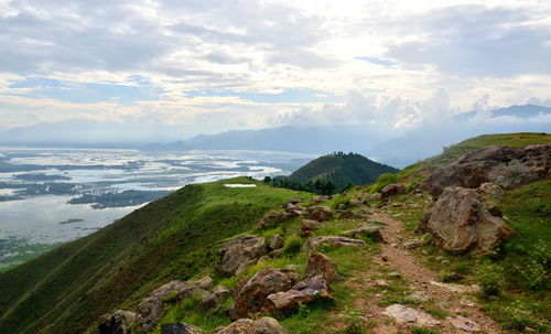 Scenic view of mountains against cloudy sky