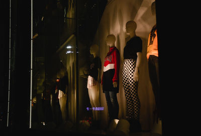 Men standing in illuminated room