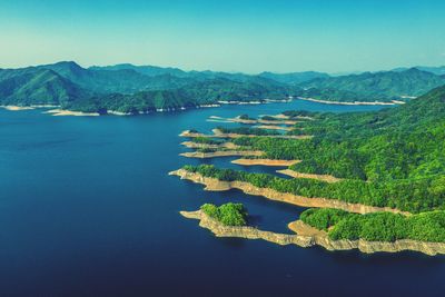 Scenic view of lake against clear blue sky