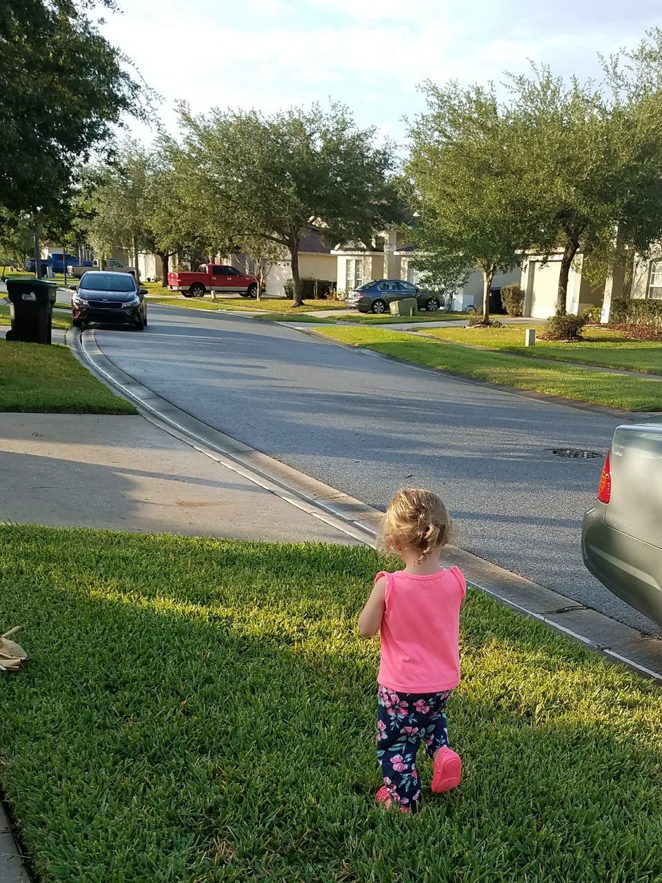 REAR VIEW OF GIRL WALKING ON ROAD