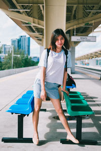 Full length of smiling woman walking outdoors