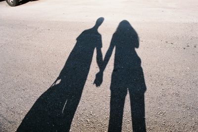 Shadow of couple on hands