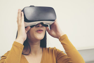 Young woman wearing virtual reality simulator