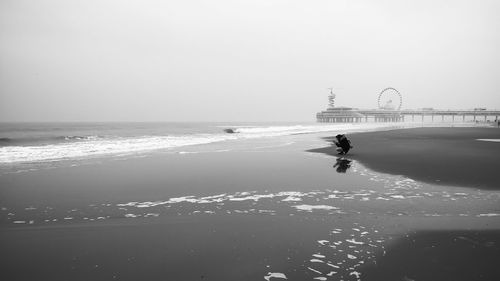 Woman at beach against sky