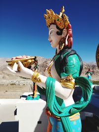 Close-up of statue against blue sky