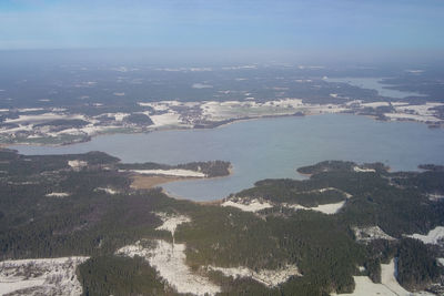 High angle view of landscape and sea against sky