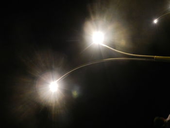 Low angle view of sun shining in sky