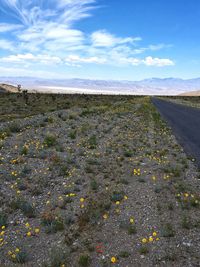 Empty road against cloudy sky