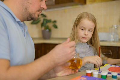 Portrait of young woman preparing food at home