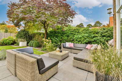 Empty chairs and tables in yard