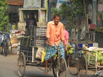 Portrait of man riding bicycle on street