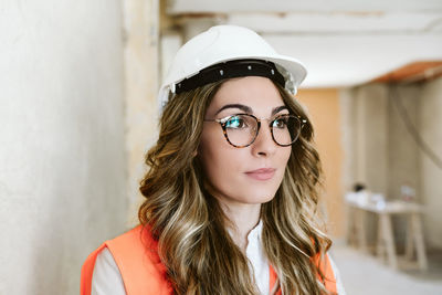 Portrait of professional confident architect woman in construction site. home renovation