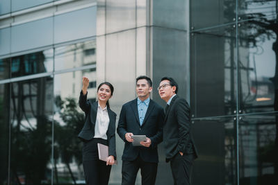 Full length of man and woman standing in city